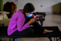 <p>A young girl affected by Hurricane Fiona looks at her phone at a shelter in Salinas, Puerto Rico September 19, 2022. REUTERS/Ricardo Arduengo</p> 