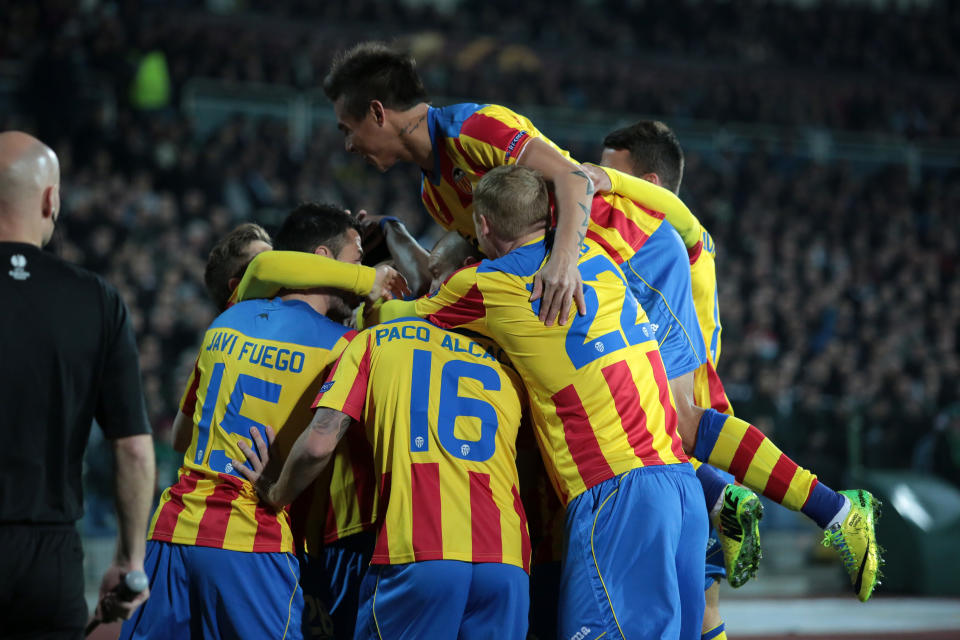Valencia players celebrate after scoring their first goal against Ludogorets during their Europa League round of 16 first leg soccer match at Vassil Levski stadium in Sofia, Thursday, March 13, 2014. (AP Photo/Valentina Petrova)