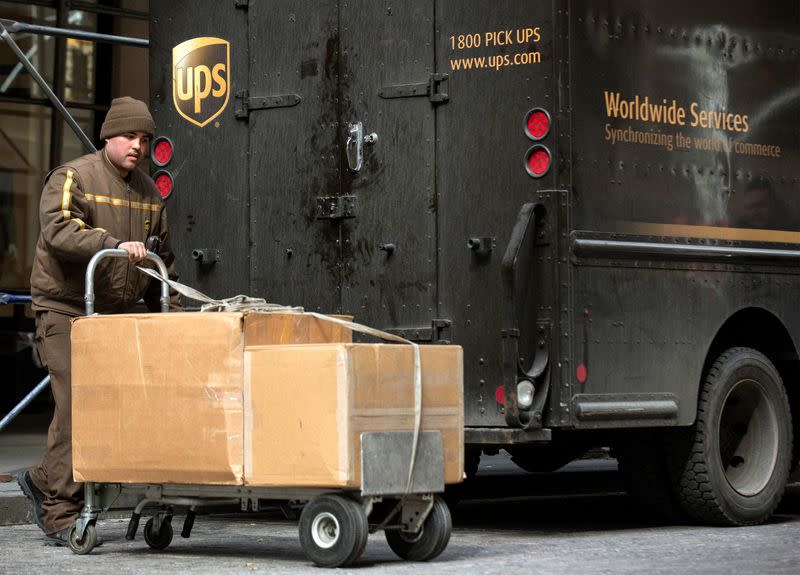 FILE PHOTO: A UPS delivery person offloads packages from a truck in New York's financial district