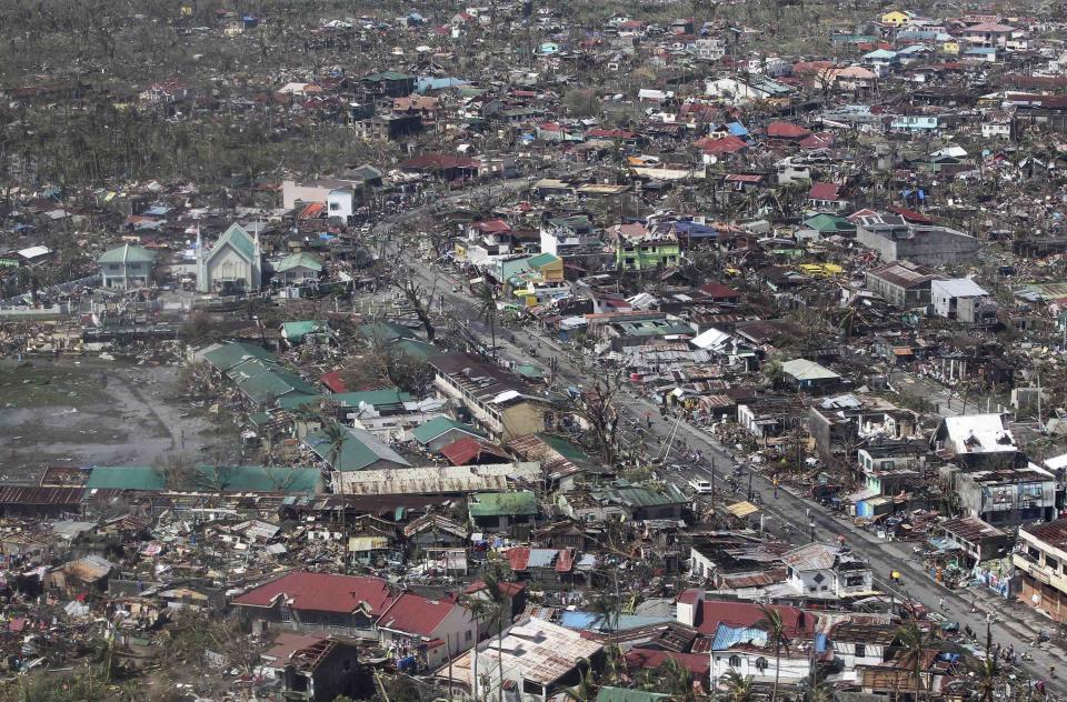 An aerial view shows damaged houses brought by Typhoon Haiyan in the province of Leyte, central Philippines November 10, 2013. One of the most powerful storms ever recorded killed at least 10,000 people in the central Philippines, a senior police official said on Sunday, with huge waves sweeping away coastal villages and devastating one of the main cities in the region. REUTERS/Ryan Lim/Malacanang Photo Bureau/Handout via Reuters (PHILIPPINES - Tags: ENVIRONMENT DISASTER) ATTENTION EDITORS - THIS IMAGE WAS PROVIDED BY A THIRD PARTY. FOR EDITORIAL USE ONLY. NOT FOR SALE FOR MARKETING OR ADVERTISING CAMPAIGNS. NO SALES. NO ARCHIVES. THIS PICTURE IS DISTRIBUTED EXACTLY AS RECEIVED BY REUTERS, AS A SERVICE TO CLIENTS