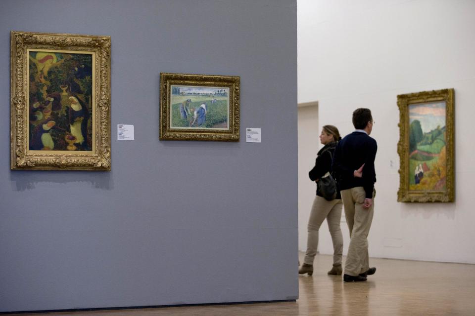 Camille Pissaro's "Peasant Women Working in the Fields", second painting from left, hangs on the spot where the stolen Henri Matisse painting was located as the Kunsthal museum reopened its doors to the public following Tuesday morning's art heist in Rotterdam, Wednesday, Oct. 17, 2012. Police investigating a multimillion euro (dollar) art heist say they are following up several tips from the public, a day after thieves grabbed seven paintings from the walls of a Rotterdam gallery and vanished into the night. A spokeswoman for detectives on the case, Willemieke Romijn, said Wednesday they have some 15 tips from the public, following a late-night, nationally televised appeal for witnesses to the theft from the Kunsthal gallery of works by celebrated artists including Pablo Picasso, Claude Monet and Henri Matisse. (AP Photo/Peter Dejong)