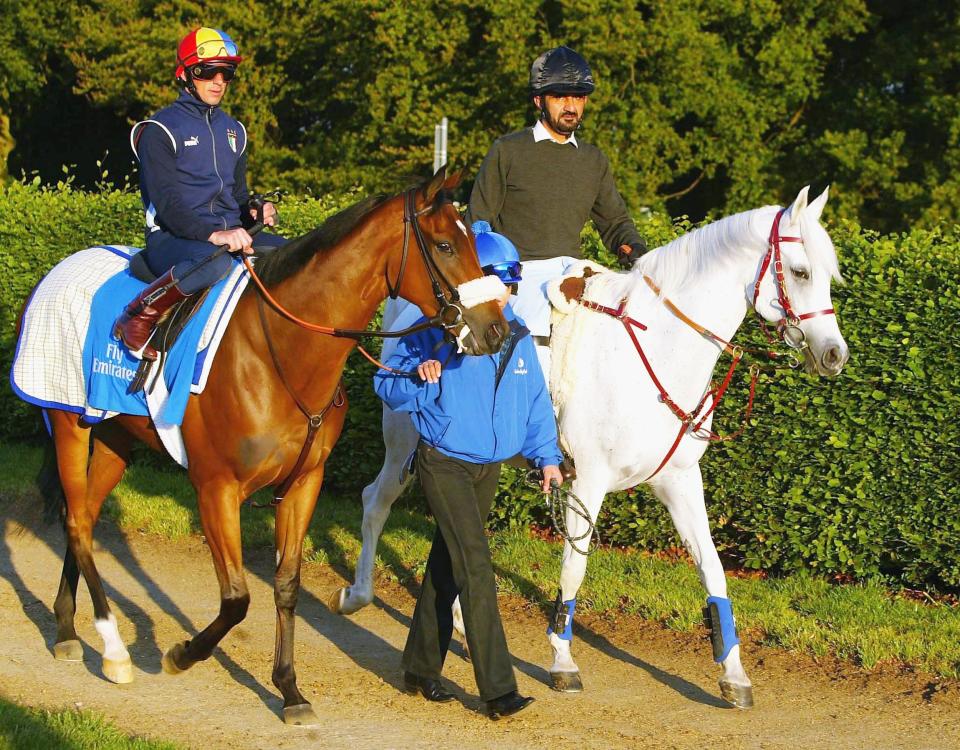 Sheikh Mohammed (R) escorts Frankie Dettori and Punctilious to the gallops at Newmarket were the Godolphin trained horse worked - Credit: Julian Herbert/Getty Images