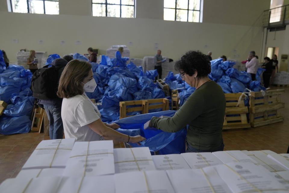 Workers pack ballots into bags, from a warehouse of the Region of Attica to be delivered to municipalities' polling stations, in Athens, Greece, Wednesday, May 17, 2023. Greeks go to the polls Sunday, May 21, in the first general election held since the country ended successive international bailout programs and strict surveillance period imposed by European leaders. Conservative Prime Minister Kyriakos Mitsotakis is seeking a second four-year term and is leading in opinions but may need a coalition partner to form the next government. (AP Photo/Thanassis Stavrakis)