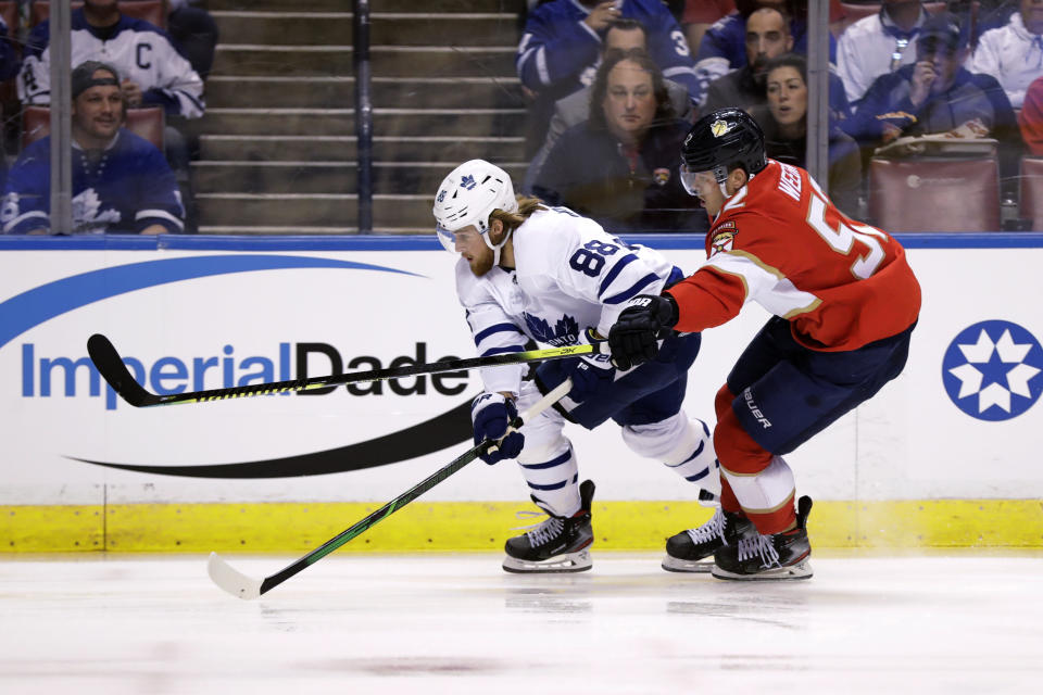 Toronto Maple Leafs right wing William Nylander (88) and Florida Panthers defenseman MacKenzie Weegar (52) vie for the puck during the first period of an NHL hockey game Thursday, Feb. 27, 2020, in Sunrise, Fla. (AP Photo/Wilfredo Lee)