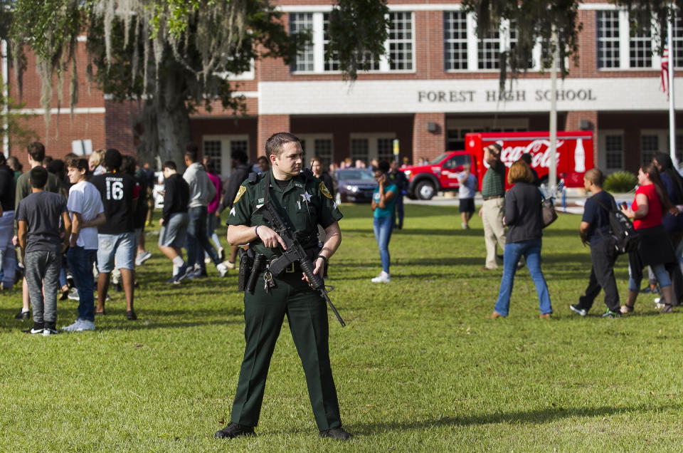 <p>A Marion County Sheriff’s Deputy stands outside Forest High School as students exit the school after a school shooting occurred, Friday, April 20, 2018 in Ocala, Fla. (Photo: Doug Engle /Star-Banner via AP) </p>