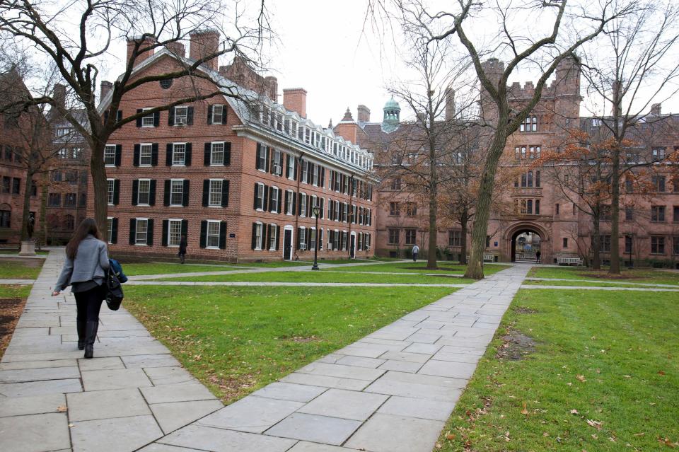 A student walks along a path at Yale