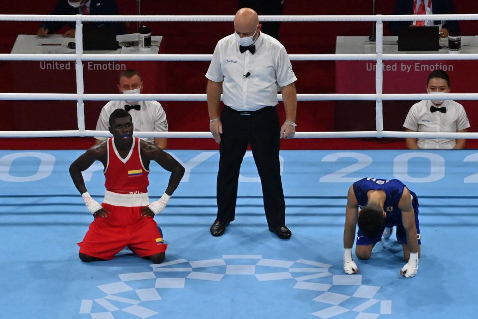 Japan's Ryomei Tanaka (blue) reacts after winning against Colombia's Yuberjen Herney Martinez Rivas after their men's fly (48-52kg) quarter-final boxing match during the Tokyo 2020 Olympic Games at the Kokugikan Arena in Tokyo on August 3, 2021. (Photo by Luis ROBAYO / AFP) (Photo by LUIS ROBAYO/AFP via Getty Images)