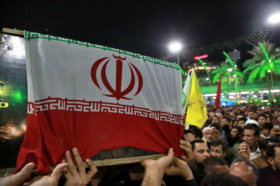 Mourners carry the coffin of Iran's top general Qassem Soleimani during his funeral in Karbala, Iraq, Saturday, Jan. 4, 2020. Iran has vowed "harsh retaliation" for the U.S. airstrike near Baghdad's airport that killed Tehran's top general and the architect of its interventions across the Middle East, as tensions soared in the wake of the targeted killing. (AP Photo/Khalid Mohammed)