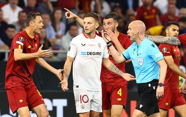 Sevilla's Loic Bade, top, heads the ball past Roma's Tammy Abraham