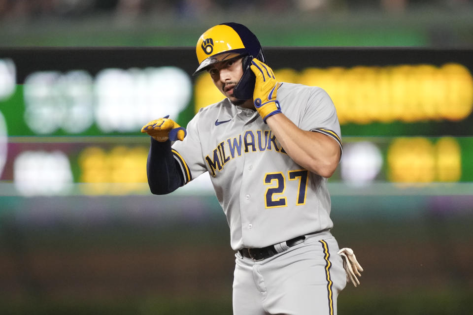 Milwaukee Brewers' Willy Adames looks back at his teammate and celebrates his RBI double off Chicago Cubs relief pitcher Drew Smyly during the seventh inning of a baseball game Monday, Aug. 28, 2023, in Chicago. (AP Photo/Charles Rex Arbogast)