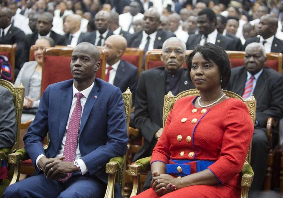 Haiti's President Jovenel Moise sits with his wife Martine during his swearing-in ceremony at Parliament in Port-au-Prince, Haiti, Tuesday Feb. 7, 2017. Moise was sworn-in as president for the next five years after a bruising two-year election cycle, inheriting a struggling economy and a deeply divided society. (AP Photo/Dieu Nalio Chery)