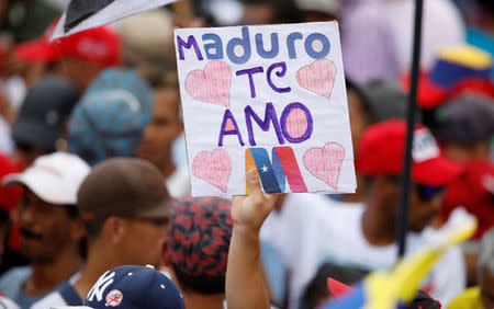 A supporter of Venezuela's President Nicolas Maduro holds a banner during a campaign rally in Caracas, Venezuela, May 17, 2018. The banner reads: "Maduro i love you". REUTERS/Carlos Garcia Rawlins