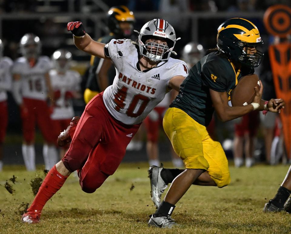 Page linebacker Eric Hazzard (40) reaches to bring down Hillsboro running back Giovanni Reames (6) during an high school football game Thursday, Oct. 5, 2023, in Nashville, Tenn.