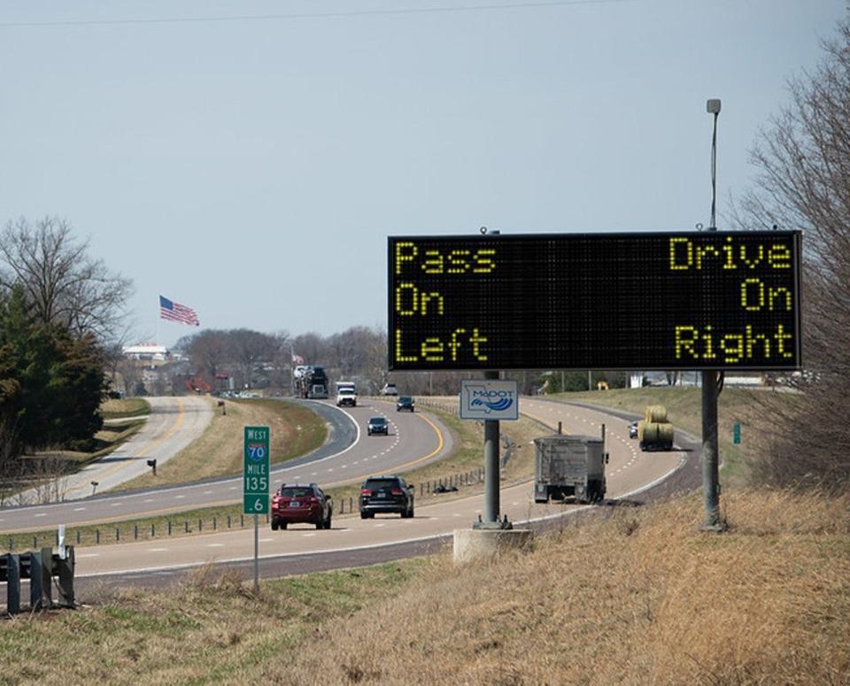 A Missouri Department of Transportation roadside safety sign urging drivers to "pass on left" and "drive on right."