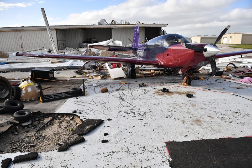 An damaged aircraft sits where there had been a hanger at the Venice Municipal Airport in Venice, Florida,  following Hurricane Ian on Thursday, Sept. 29, 2022. Winds from the storm ripped steel posts out of the ground and lifted the entire hanger away.