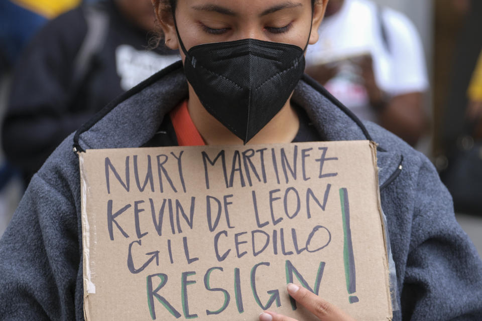 A protester holding a sign protest outside City Hall during the Los Angeles City Council meeting Tuesday, Oct. 11, 2022 in Los Angeles. (AP Photo/Ringo H.W. Chiu)