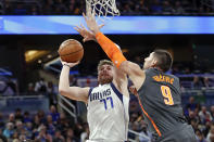 Dallas Mavericks guard Luka Doncic (77) shoots over Orlando Magic center Nikola Vucevic (9) during the first half of an NBA basketball game, Friday, Feb. 21, 2020, in Orlando, Fla. (AP Photo/John Raoux)