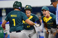 Australia's Michelle Cox (47) and Taylah Tsitsikronis, right, cheer for Jade Wall (1) as she rounds the basses after hitting a home run in the sixth inning of a softball game against Mexico at the 2020 Summer Olympics, Monday, July 26, 2021, in Yokohama, Japan. (AP Photo/Matt Slocum)