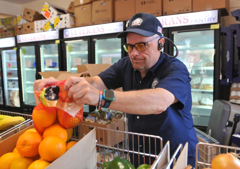 Cape and Islands Veterans Outreach Center Operations Manager Michael Gleason fills up a box of oranges for veterans visiting the center's food distribution program. Volunteers and staff worked together to fulfill grocery lists for veterans at the Cape & Islands Veterans Outreach Center food pantry in Hyannis.