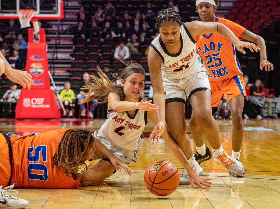 Byron's Macy Groharing (4) and Malia Morton (21) scramble for a loose ball during the second quarter of the Class 2A state semifinal game on Thursday, March 2, 2023.