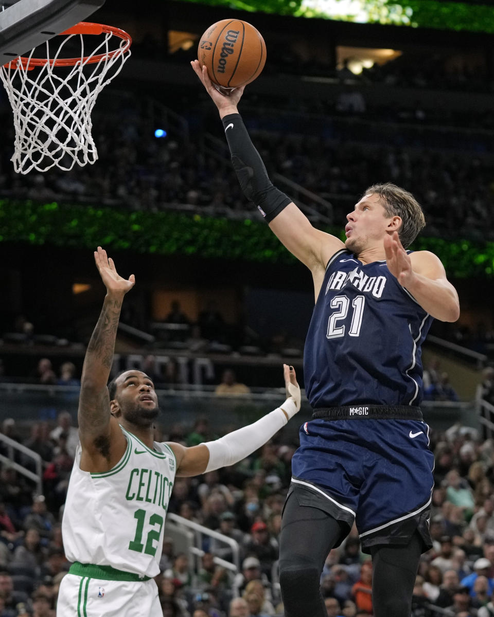 Orlando Magic center Moritz Wagner (21) makes a shot over Boston Celtics forward Oshae Brissett (12) during the second half of an NBA basketball game, Friday, Nov. 24, 2023, in Orlando, Fla. (AP Photo/John Raoux)