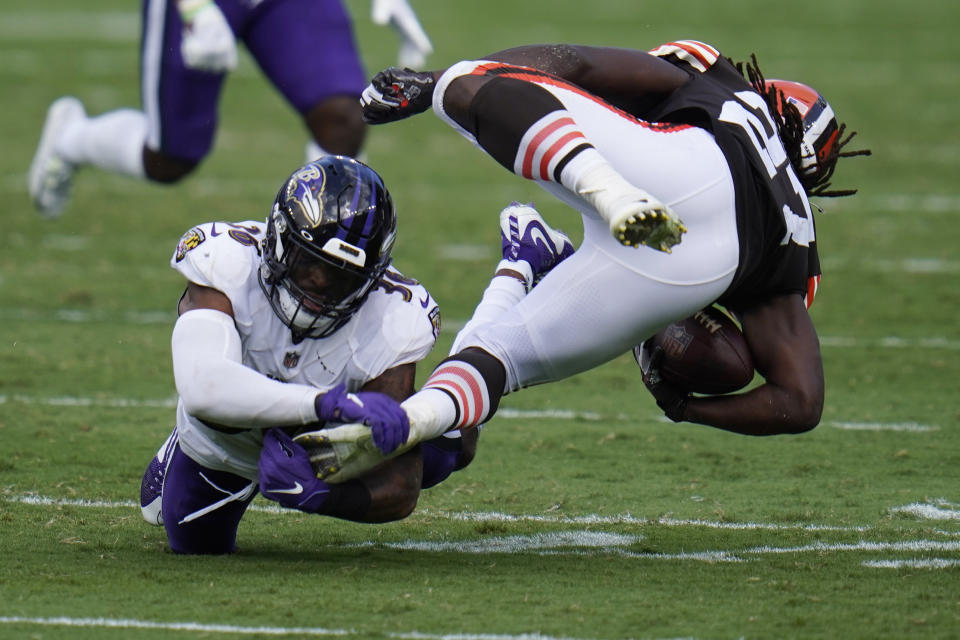 Baltimore Ravens safety Chuck Clark (36) grabs Cleveland Browns running back Kareem Hunt's (27) foot, during the second half of an NFL football game, Sunday, Sept. 13, 2020, in Baltimore, MD. (AP Photo/Julio Cortez)