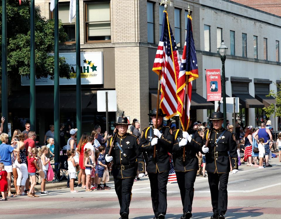 The Fairfield County Sheriff's Office Honor Guard marches through downtown Lancaster in the Lancaster-Fairfield County 4th of July Parade last year. This year's parade will start at 10 a.m. Monday.