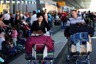 People gather outside Frankfurt airport terminal after Terminal 1 departure hall was evacuated in Frankfurt, Germany, August 31, 2016. REUTERS/Alex Kraus