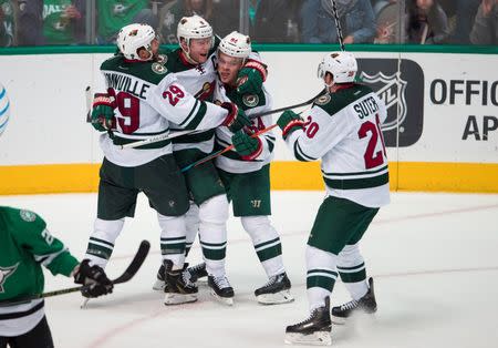 Apr 22, 2016; Dallas, TX, USA; Minnesota Wild center Mikko Koivu (9) and right wing Jason Pominville (29) and defenseman Ryan Suter (20) and center Mikael Granlund (64) celebrate Koivu's game tying goal against the Dallas Stars during the third period in game five of the first round of the 2016 Stanley Cup Playoffs at the American Airlines Center. Mandatory Credit: Jerome Miron-USA TODAY Sports