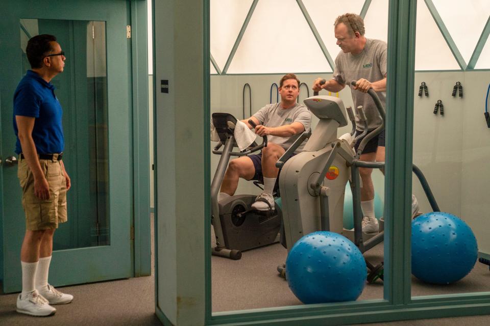 Astronaut hopefuls Skip (Fred Armisen), left, Rook (Tim Heidecker) and Cap (John C. Reilly) share a small gym in their isolated desert compound in the Showtime comedy, 'Moonbase 8.'