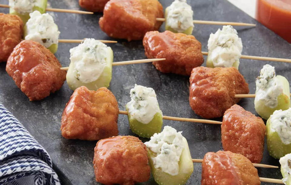 <p>Say hello to your new favorite game day snack. These skewers alternate Buffalo chicken chunks, celery and crumbled blue cheese for a three-in-one bite. </p> <p><a href="https://www.thedailymeal.com/recipe/buffalo-chicken-skewer-recipe?referrer=yahoo&category=beauty_food&include_utm=1&utm_medium=referral&utm_source=yahoo&utm_campaign=feed" rel="nofollow noopener" target="_blank" data-ylk="slk:For the Buffalo Chicken Skewers recipe, click here.;elm:context_link;itc:0;sec:content-canvas" class="link ">For the Buffalo Chicken Skewers recipe, click here. </a></p>