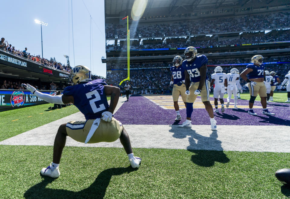 Washington wide receiver Ja'Lynn Polk (2) celebrates after a touchdown as running back Sam Adams II (28) and tight end Devin Culp (83) also celebrate during the first half of an NCAA college football game against Tulsa, Saturday, Sept. 9, 2023, in Seattle. (AP Photo/Lindsey Wasson)