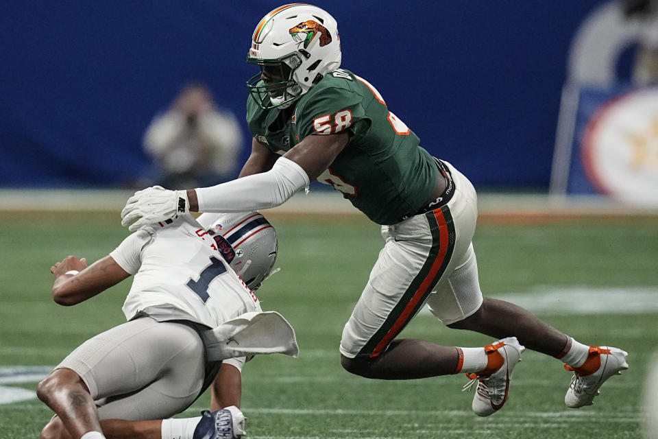 Florida A&M defensive lineman Anthony Dunn Jr. (58) sacks Howard quarterback Quinton Williams (1) during the first half of an NCAA Celebration Bowl football game, Saturday, Dec. 16, 2023, in Atlanta. (AP Photo/Mike Stewart)