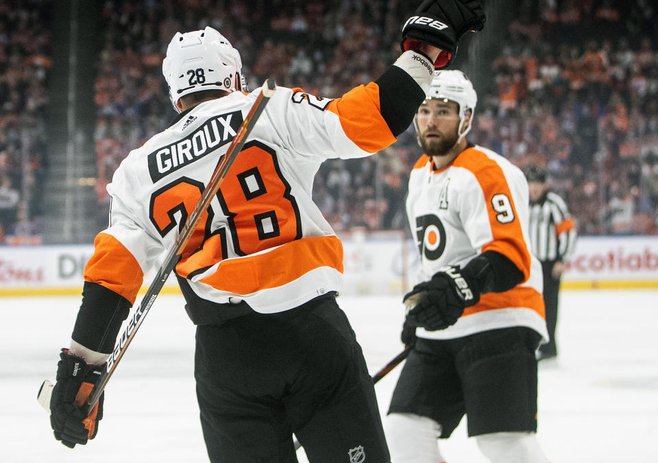 Philadelphia Flyers' Claude Giroux (28) and Ivan Provorov (9) celebrate a goal against the Edmonton Oilers during the first period of an NHL hockey game, Wednesday, Oct. 27, 2021 in Edmonton, Alberta. (Jason Franson/The Canadian Press via AP)