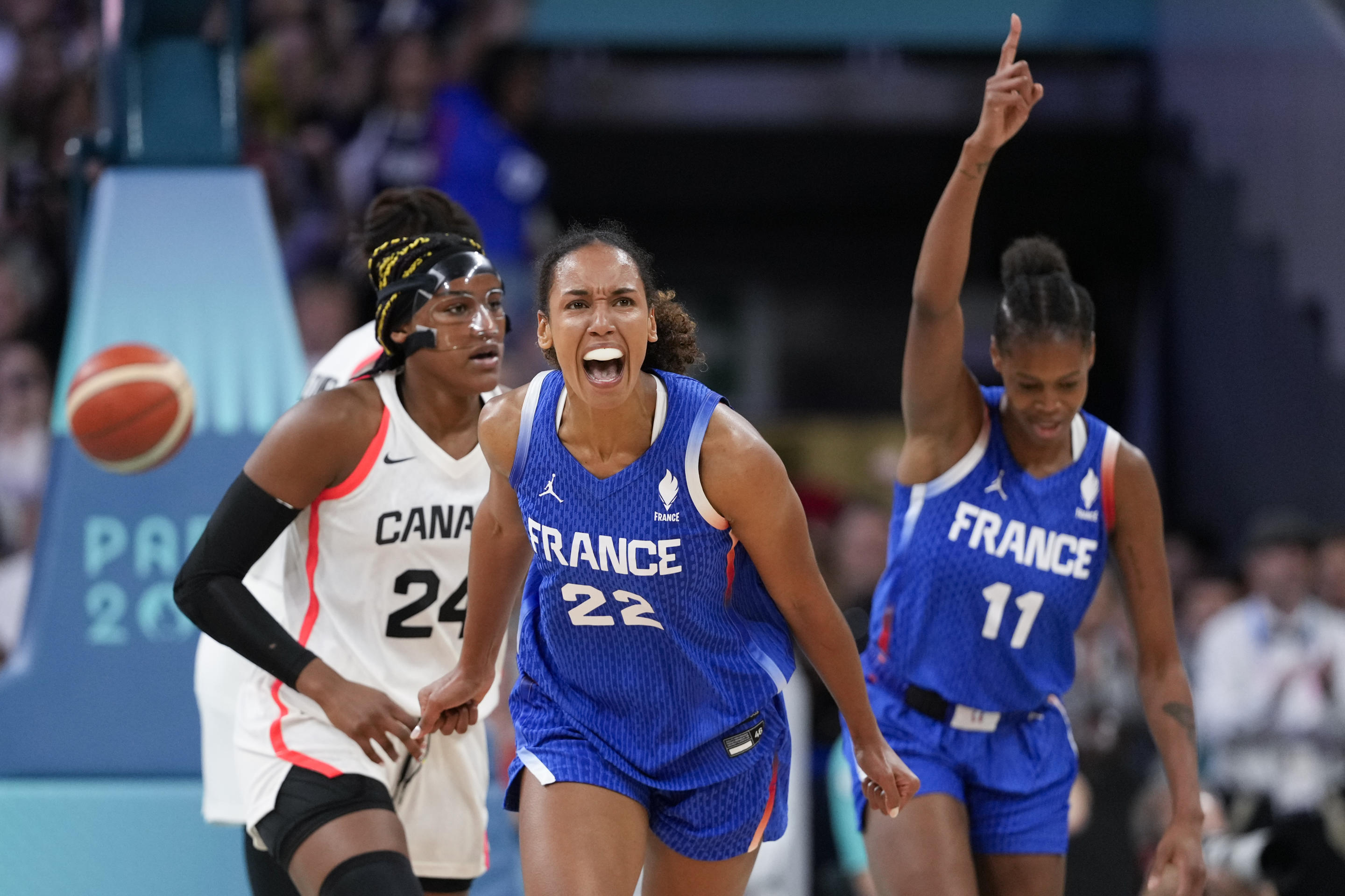 Marieme Badiane (22) and Valeriane Ayayi, of France, celebrates in a women's basketball game against Canada at the 2024 Summer Olympics on July 29, 2024, in Villeneuve-d'Ascq, France. (Mark J. Terrill/AP)