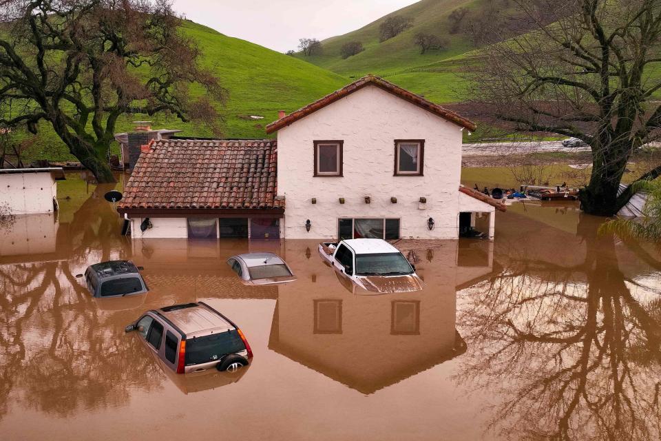 Heavy rain lashed water-logged California Monday, with forecasters warning of floods as a parade of storms that have killed 12 people battered the western United States.  (Josh Edelson / AFP - Getty Images)