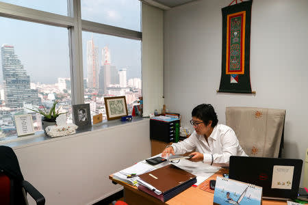 Boodsabann Chanthawong, 49, a businesswoman, works at her office, weeks ahead of her ordination to be a novice monk in Bangkok, Thailand, November 22, 2018. REUTERS/Athit Perawongmetha