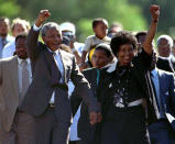 Nelson Mandela, who spent 27 years in apartheid jails as the world's most important political prisoner, walked free from Victor Verster prison, near Cape Town, on February 11, 1990. Mandela is accompanied by his former wife Winnie, moments after his release from prison in this February 11, 1990 file photo. (Reuters)