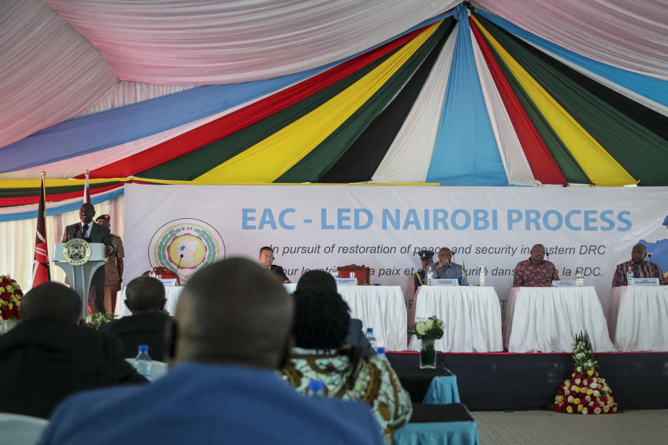 Kenya's President William Ruto, left at podium, speaks at the opening of the Third Inter-Congolese Consultations of the Nairobi Peace Process, the political track, Nairobi III, at a hotel in Nairobi, Kenya Monday, Nov. 28, 2022. The East African Community (EAC) led summit aims to find solutions to the ongoing armed conflict in Eastern Congo. (AP Photo/Brian Inganga)