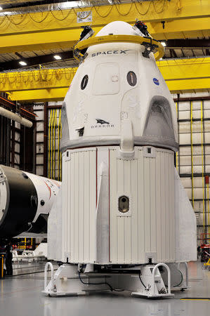 The Dragon crew capsule sits in the SpaceX hangar at Launch Complex 39-A, where the space ship and Falcon 9 booster rocket are being prepared for a January 2019 launch at Cape Canaveral, Florida, U.S. December 18, 2018. REUTERS/Steve Nesius