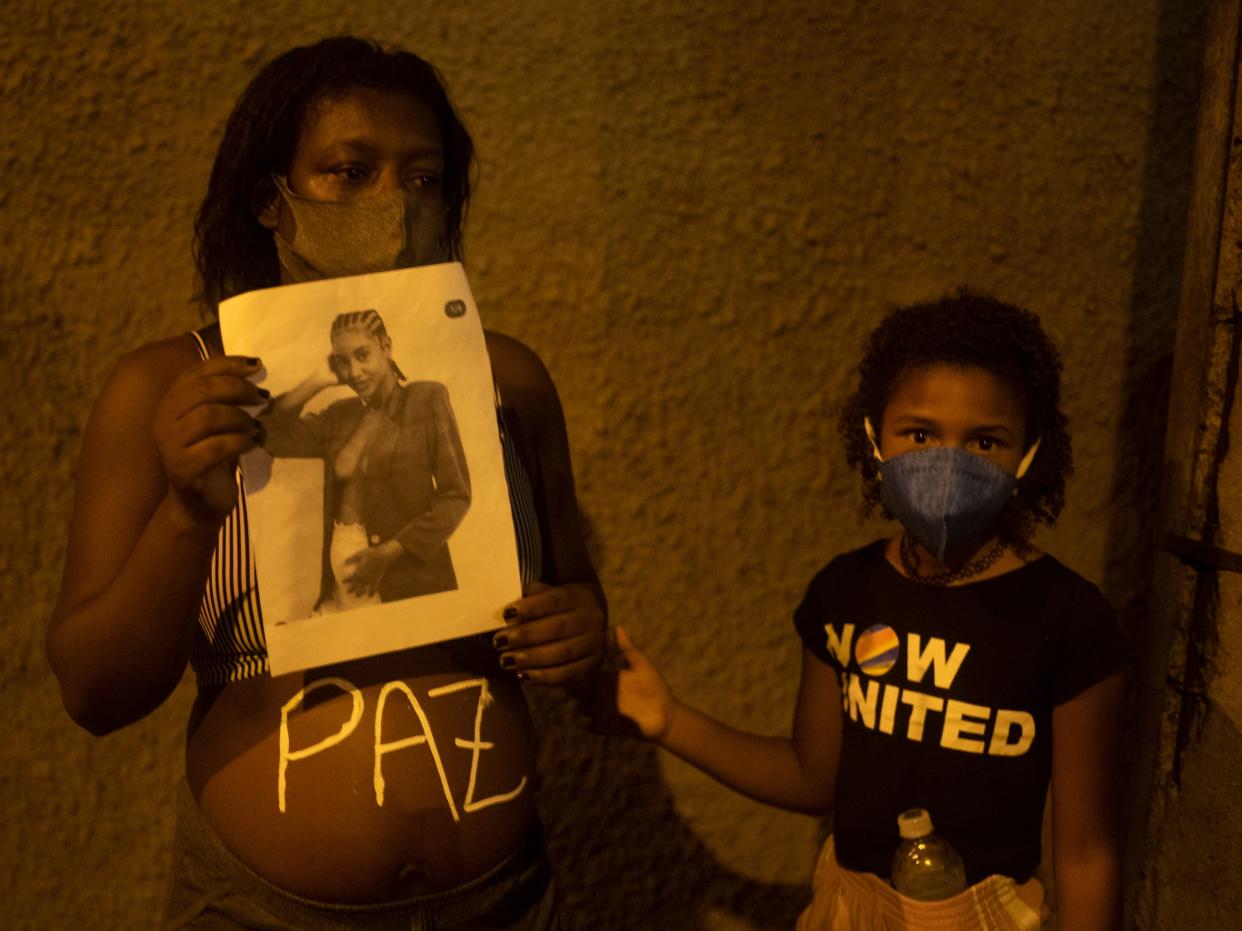 Demonstrator holds the photo of Kathlen Romeu in Rio de Janeiro, Brazil on June 9, 2021.