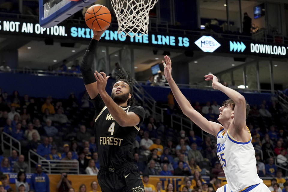 Wake Forest forward Efton Reid III (4) puts a shot up as Pittsburgh forward Guillermo Diaz Graham (25) defends during the first half of an NCAA college basketball game Wednesday, Jan. 31, 2024, in Pittsburgh. (AP Photo/Matt Freed)