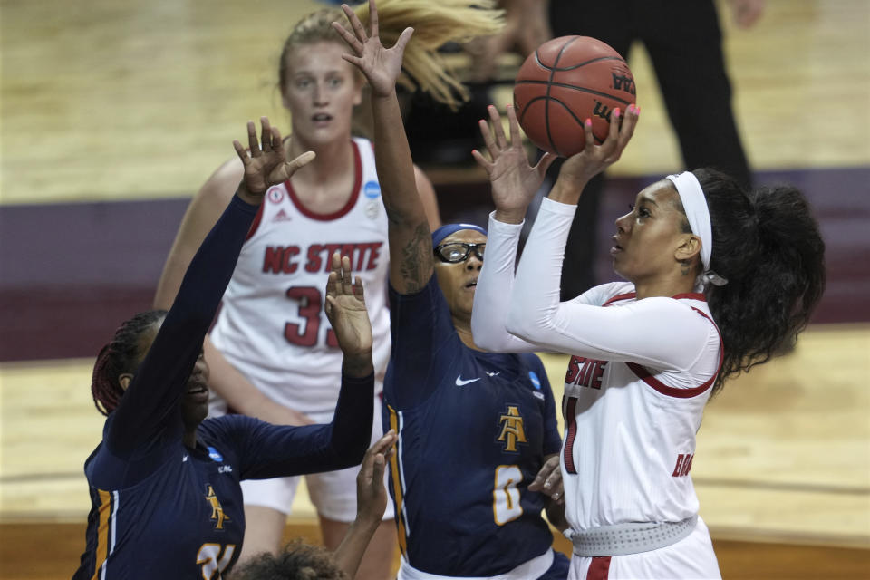 North Carolina State's Jakia Brown-Turner (11) shoots against North Carolina A&T's Jasmen Walton (0) and Jayla Jones-Pack (31) during the first half of a college basketball game in the first round of the women's NCAA tournament at the University Events Center in San Marcos, Texas, Sunday, March 21, 2021. (AP Photo/Chuck Burton)