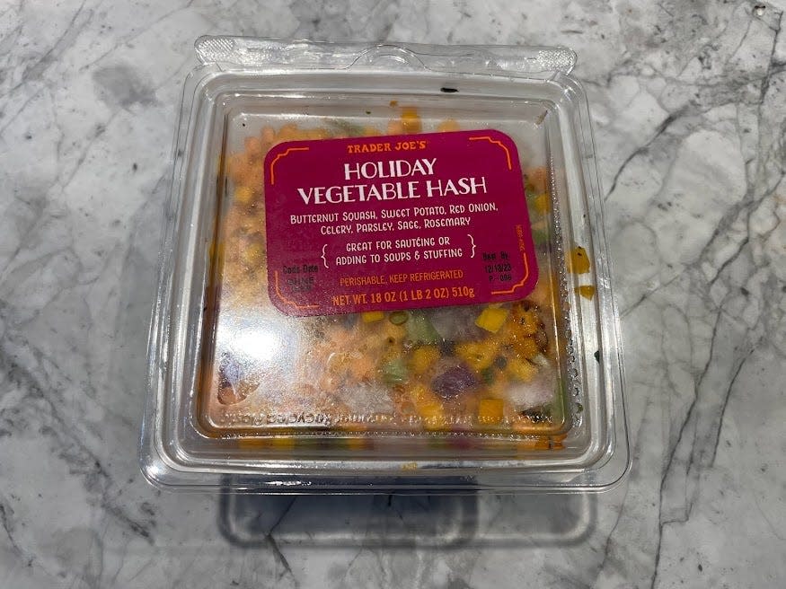 Clear container of Trader Joe's vegetable holiday hash with a pink label on a gray counter