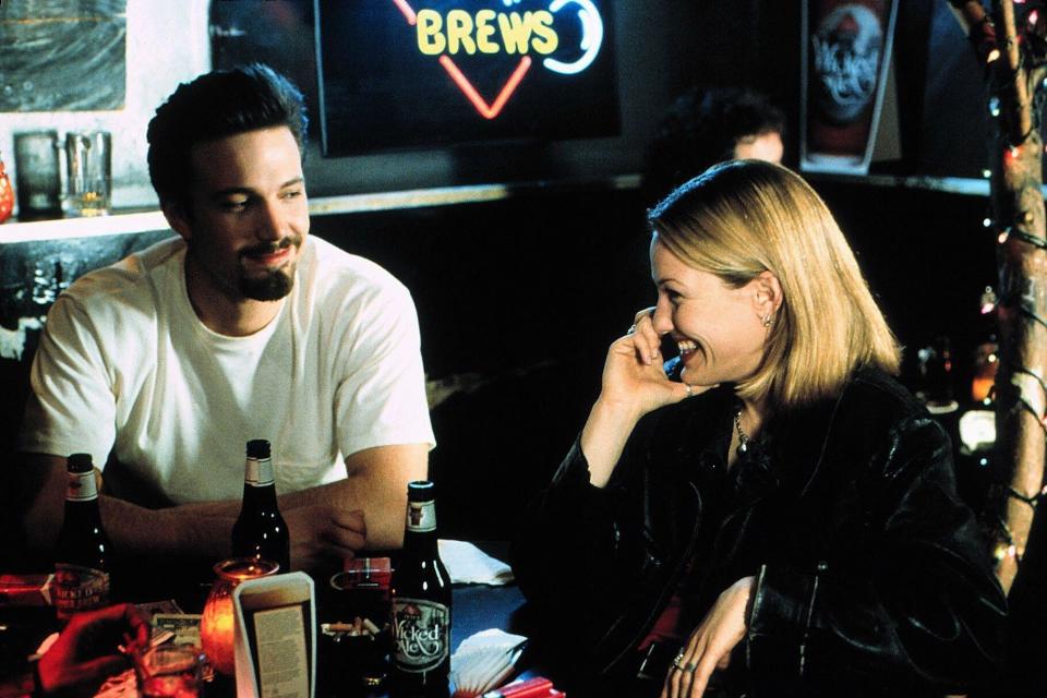 A man with a goatee drinks beers alongside a smiling blonde woman