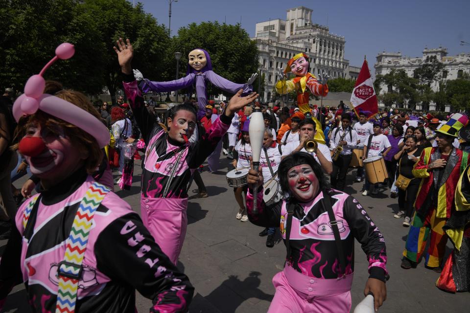 Clowns gather in the San Martin plaza to celebrate The Day of the Peruvian Clown, in Lima, Peru, Saturday, May 25, 2024. Professional clowns gather annually on this date to honor the beloved clown "Tony Perejil" who died on May 25, 1987 and was known as "the clown of the poor" because he performed in low-income neighborhoods to which he would donate a portion of his earnings. (AP Photo/Martin Mejia)