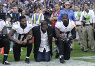 <p>Baltimore Ravens wide receiver Mike Wallace, from left, former player Ray Lewis and inside linebacker C.J. Mosley lock arms and kneel down during the playing of the U.S. national anthem before an NFL football game against the Jacksonville Jaguars at Wembley Stadium in London, Sunday Sept. 24, 2017. (AP Photo/Matt Dunham) </p>