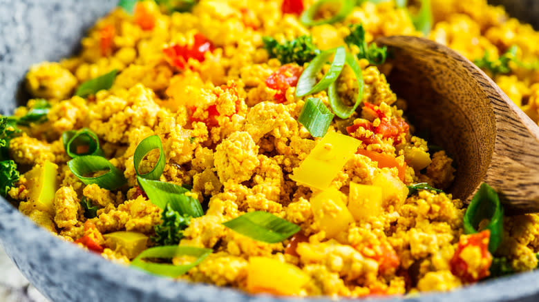 Scrambled tofu in pan with vegetables