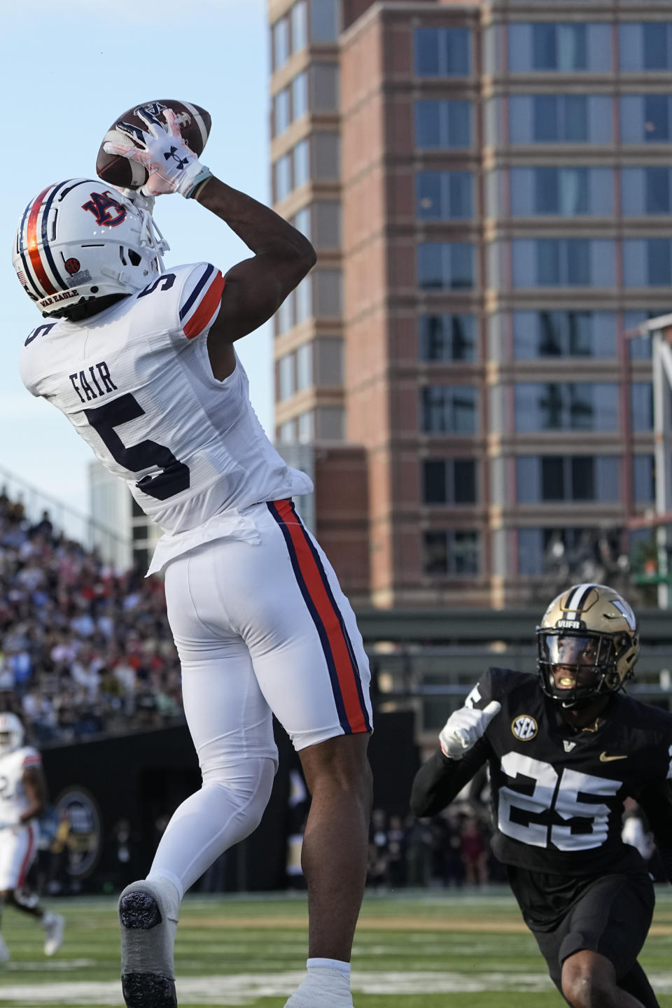 Auburn wide receiver Jay Fair (5) makes a catch over Vanderbilt cornerback Martel Hight (25) in the first half of an NCAA college football game Saturday, Nov. 4, 2023, in Nashville, Tenn. (AP Photo/George Walker IV)