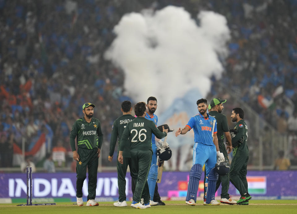 Pakistani players congratulate India's Shreyas Iyer and KL Rahul after India won by 7 wickets during the ICC Men's Cricket World Cup in Ahmedabad, India, Saturday, Oct. 14, 2023. (AP Photo/Aijaz Rahi)